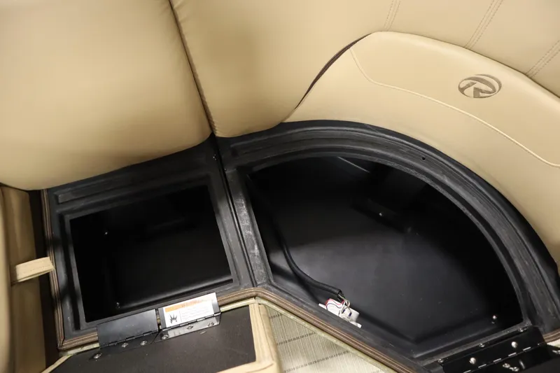 Slide: The Image of 2018 Lowe 230 Retreat WT boat storage compartments with beige seating. - 13