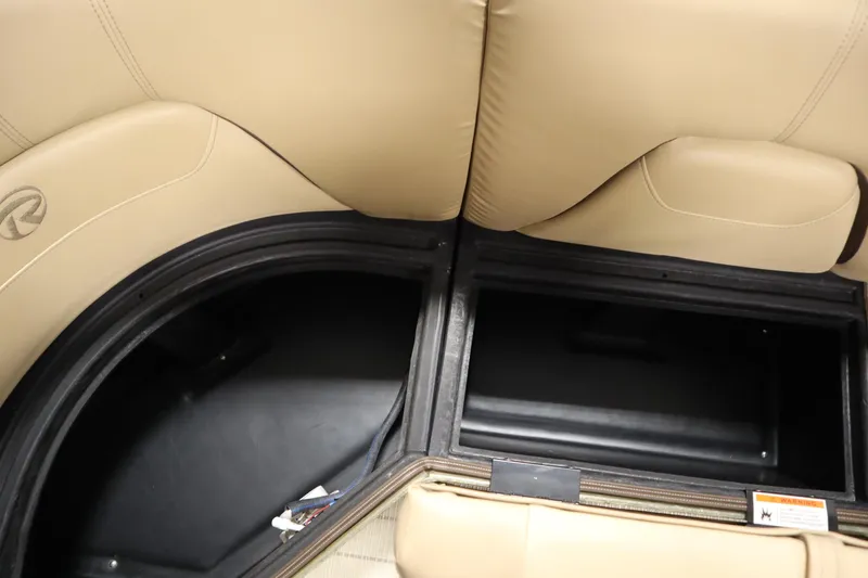 Slide: The Image of Interior storage compartments of a 2018 Lowe 230 Retreat WT boat with beige seating. - 15