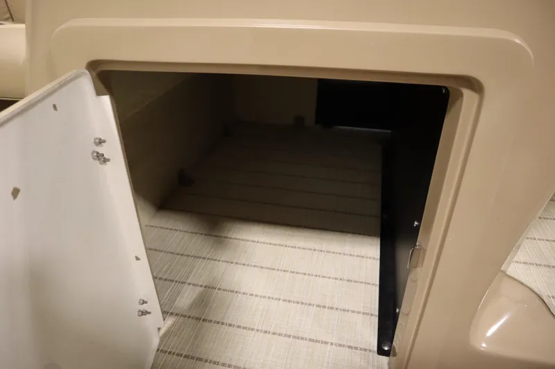 Slide: The Image of Open storage compartment in 2018 Lowe 230 Retreat WT boat. - 17