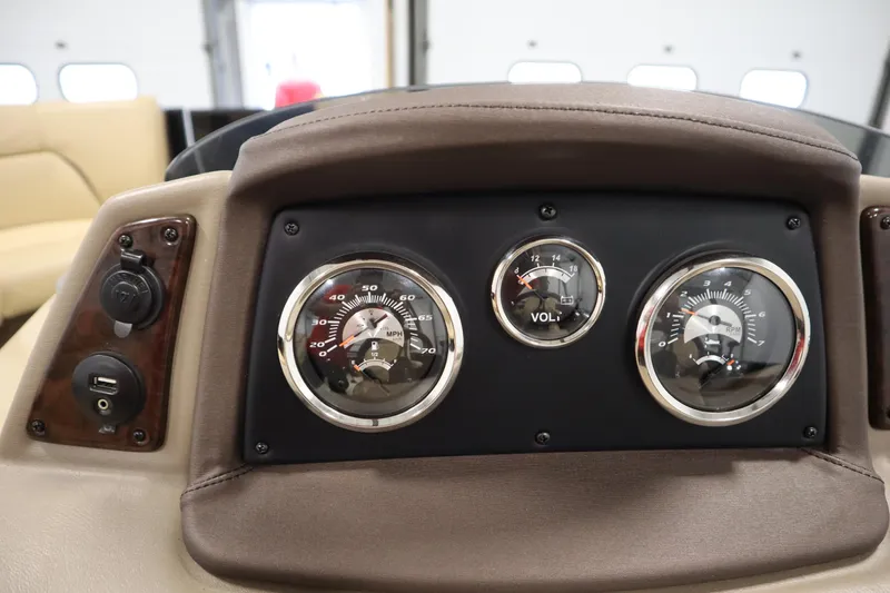 Slide: The Image of Dashboard of a 2018 Lowe 230 Retreat WT boat with gauges and USB port. - 20