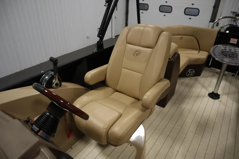 Slide: The Image of Luxurious interior of 2018 Lowe 230 Retreat WT boat with plush seating and steering wheel. - 26