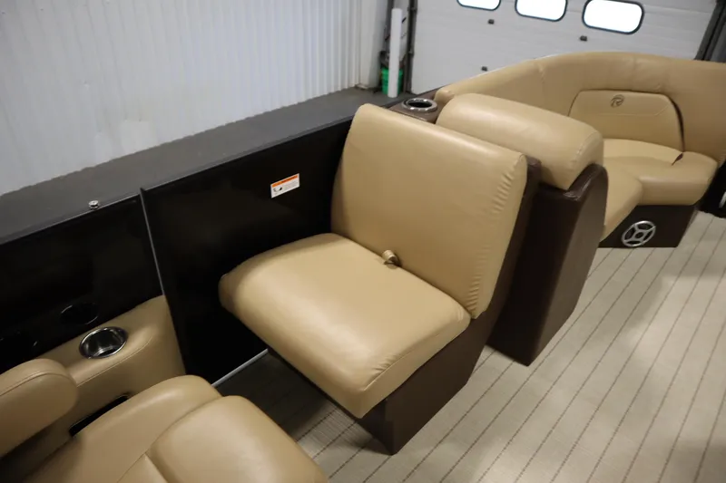 Slide: The Image of 2018 Lowe 230 Retreat WT boat interior with beige seating and cup holders. - 27