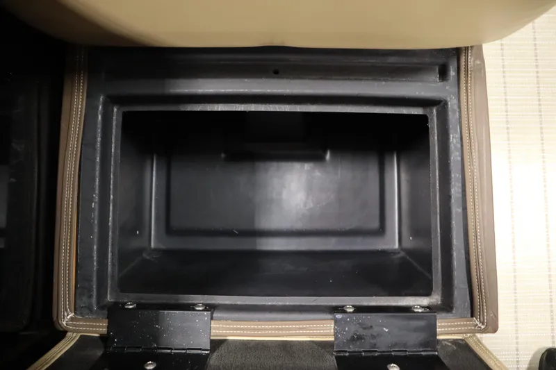 Slide: The Image of Storage compartment in 2018 Lowe 230 Retreat WT boat, featuring durable black interior. - 28