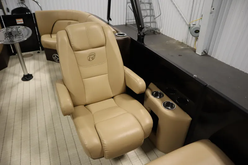 Slide: The Image of 2018 Lowe 230 Retreat WT boat interior with tan leather seating and cup holders. - 29