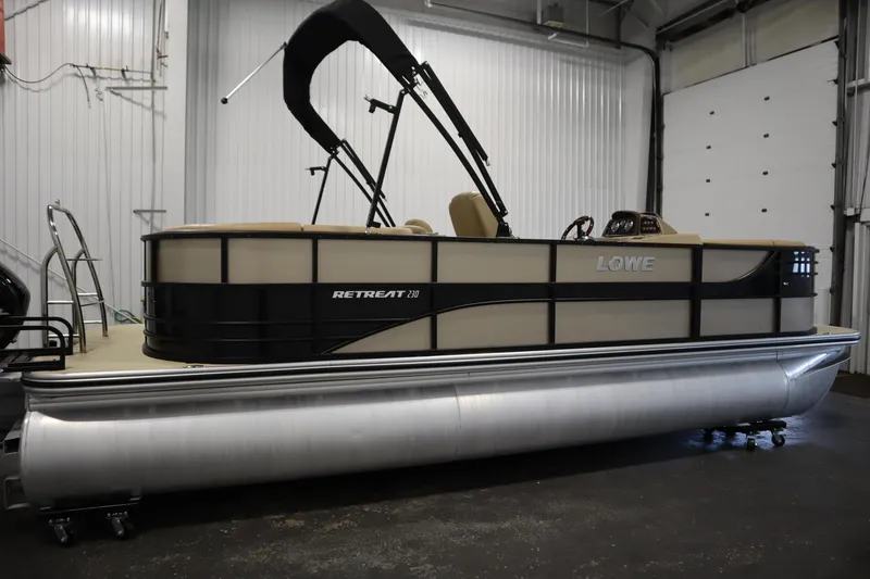 Slide: The Image of 2018 Lowe 230 Retreat WT pontoon boat in a garage setting. - 3