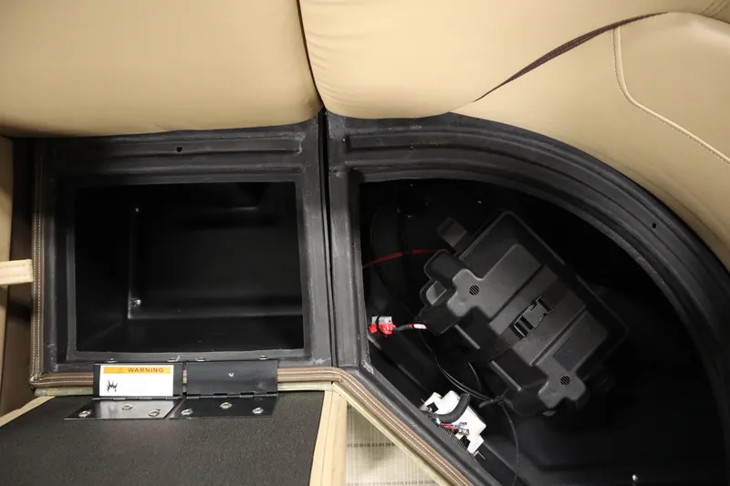 Slide: The Image of 2018 Lowe 230 Retreat WT storage compartment with battery and wiring. - 36