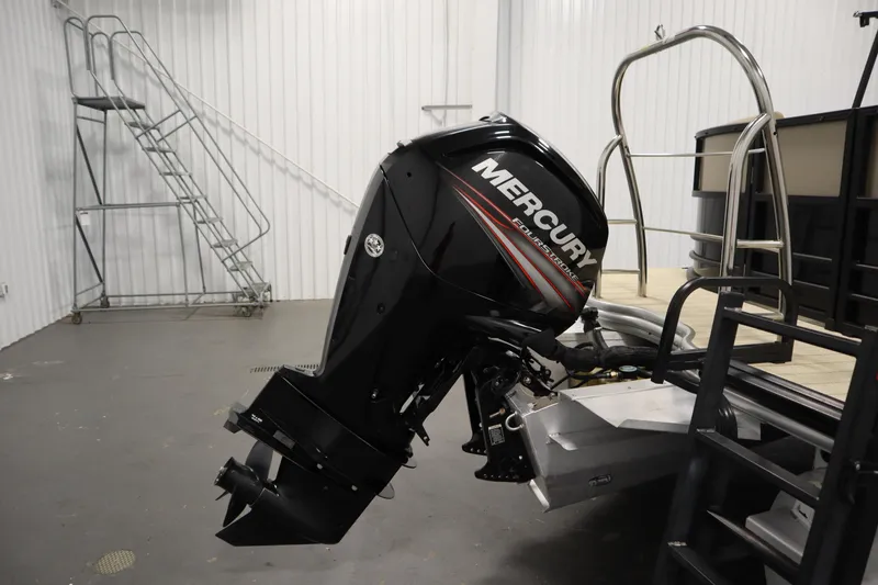 Slide: The Image of 2018 Lowe 230 Retreat WT with Mercury outboard motor in a storage facility. - 39