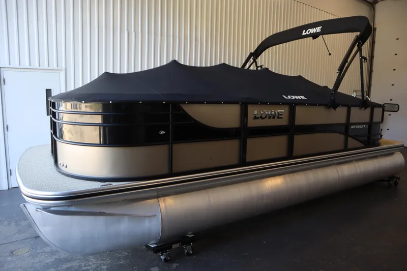 Slide: The Image of 2018 Lowe 230 Retreat WT pontoon boat with black cover in indoor storage. - 42