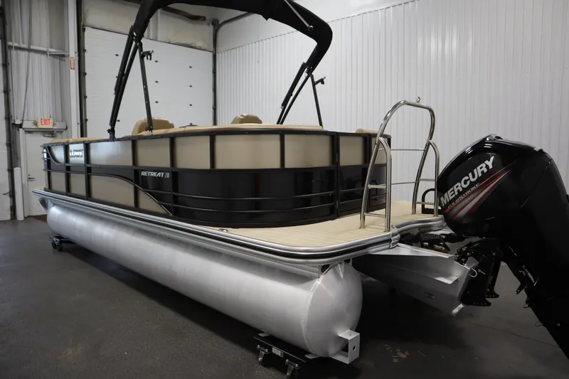 Slide: The Image of 2018 Lowe 230 Retreat WT pontoon boat with Mercury engine in a garage setting. - 6
