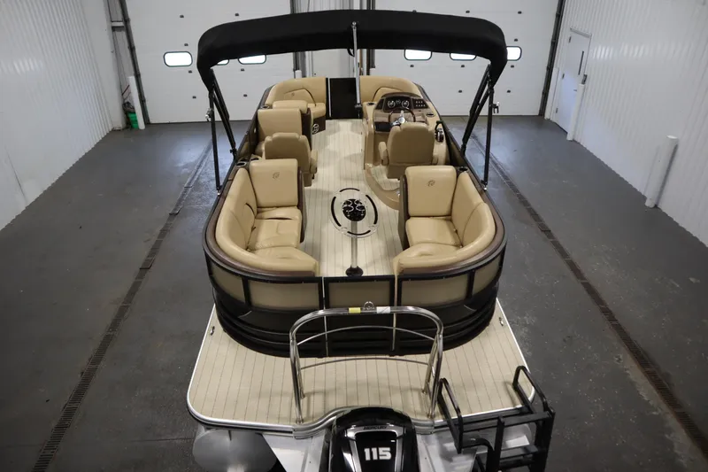 Slide: The Image of 2018 Lowe 230 Retreat WT pontoon boat with beige seating in a garage. - 9