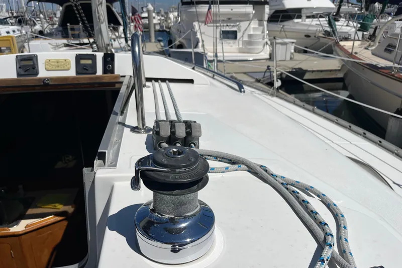 Slide: The Image of 1988 Hunter 37.5 sailboat deck with winch and ropes at marina. - 11