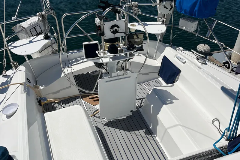 Slide: The Image of 1988 Hunter 37.5 sailboat cockpit with steering wheel and navigation equipment. - 13