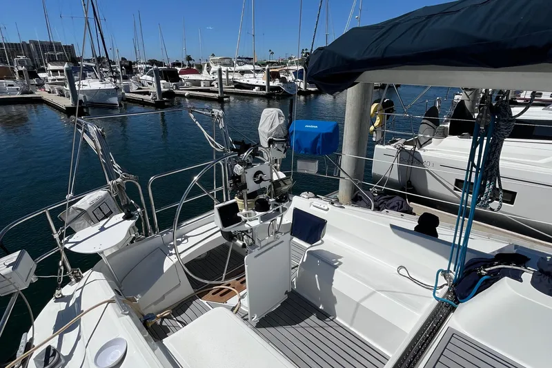 Slide: The Image of 1988 Hunter 37.5 sailboat docked in marina, surrounded by other boats. - 14