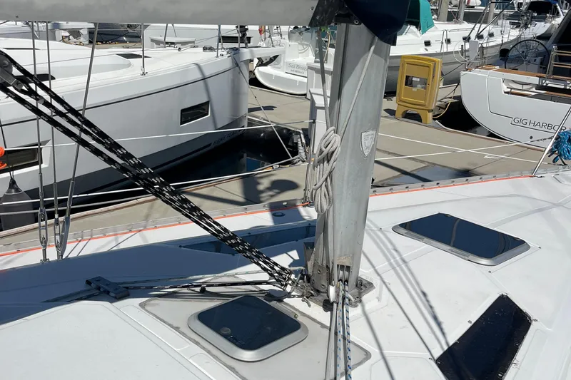 Slide: The Image of 1988 Hunter 37.5 sailboat deck with rigging and hatches at marina. - 16