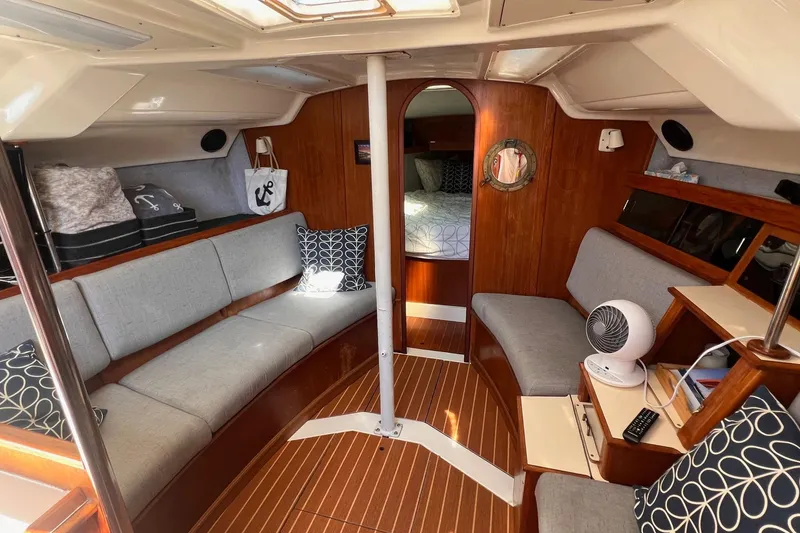 Slide: The Image of Interior of a 1988 Hunter 37.5 sailboat with cozy seating and wooden finishes. - 19