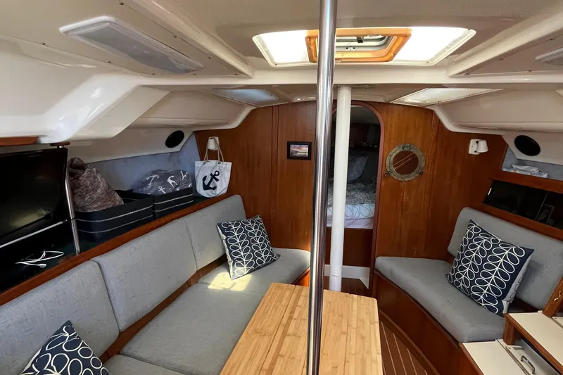 Slide: The Image of 1988 Hunter 37.5 yacht interior with cozy seating and nautical decor. - 20