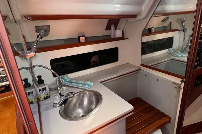 Slide: The Image of 1988 Hunter 37.5 yacht interior with sink, wooden accents, and modern fixtures. - 22