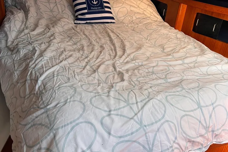 Slide: The Image of Cozy cabin bed in 1988 Hunter 37.5 sailboat with nautical-themed pillow. - 25