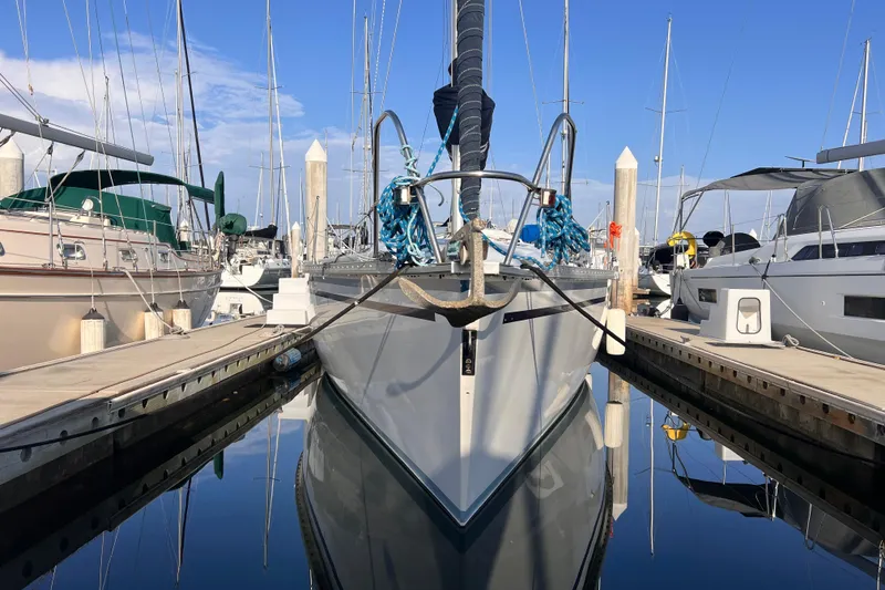 Slide: The Image of 1988 Hunter 37.5 sailboat docked at marina, surrounded by other boats. - 3