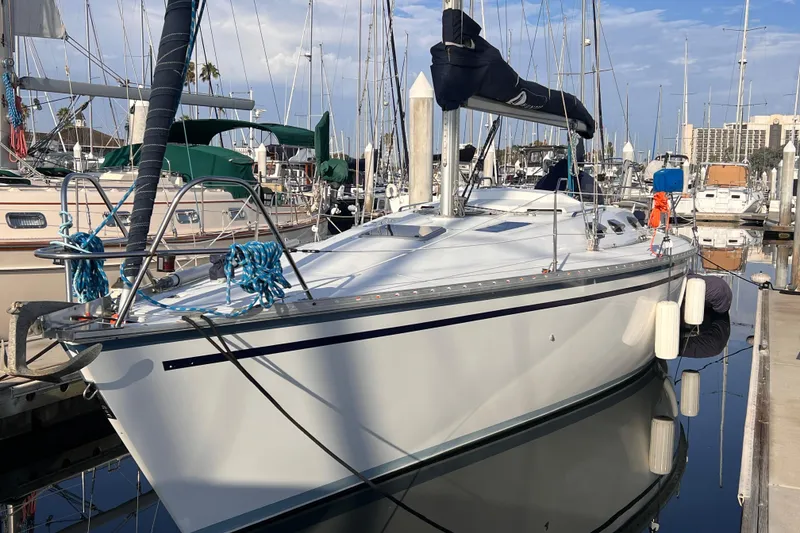Slide: The Image of 1988 Hunter 37.5 sailboat docked at marina, surrounded by other boats. - 5