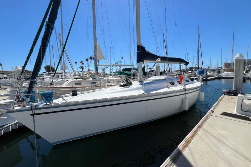 Slide: The Image of 1988 Hunter 37.5 sailboat docked at marina under clear blue sky. - 6