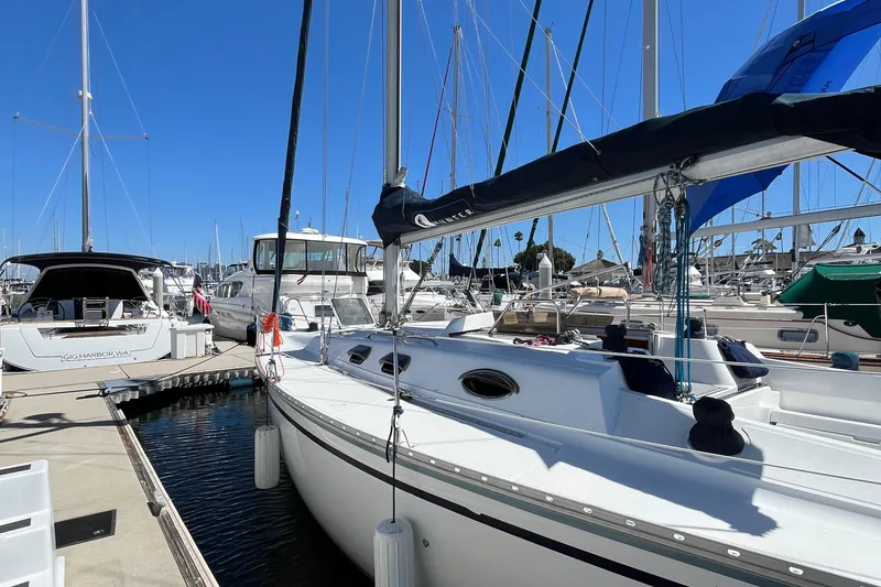 Slide: The Image of 1988 Hunter 37.5 sailboat docked at marina under clear blue sky. - 8