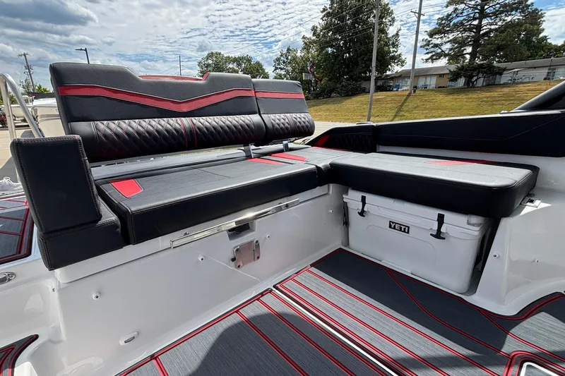 Slide: The Image of Luxurious seating on 2026 Monterey Elite 27 OB boat with stylish black and red upholstery. - 11