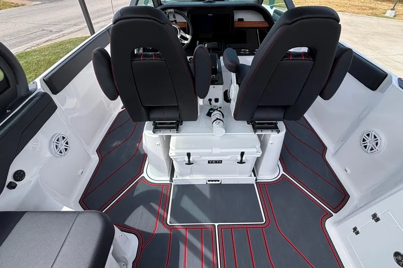 Slide: The Image of Interior of 2026 Monterey Elite 27 OB boat with sleek seating and modern design. - 12