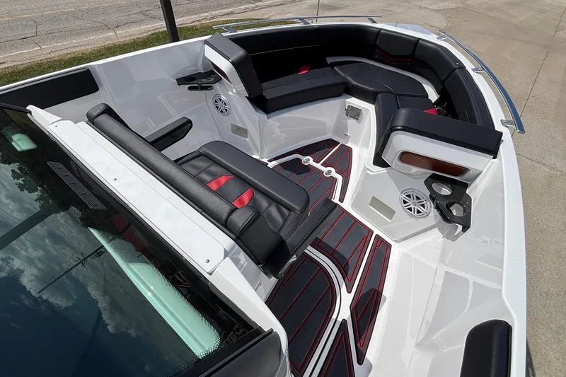 Slide: The Image of 2026 Monterey Elite 27 OB boat interior with black and red seating, cup holders, and speakers. - 16