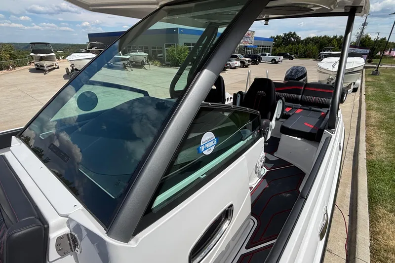 Slide: The Image of 2026 Monterey Elite 27 OB boat with sleek design and modern interior at a dealership. - 19