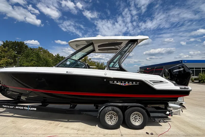 Slide: The Image of 2026 Monterey Elite 27 OB boat on trailer under a blue sky. - 2