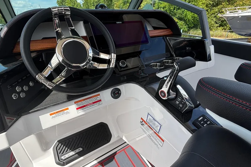 Slide: The Image of 2026 Monterey Elite 27 OB boat dashboard with steering wheel and control panel. - 23