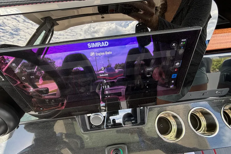 Slide: The Image of Dashboard of 2026 Monterey Elite 27 OB with Simrad display showing engine data. - 27