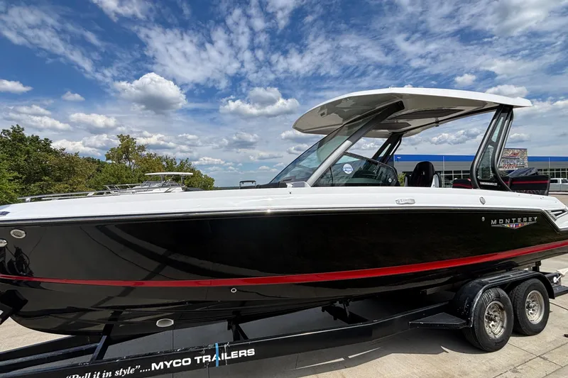 Slide: The Image of 2026 Monterey Elite 27 OB boat on trailer under a partly cloudy sky. - 3