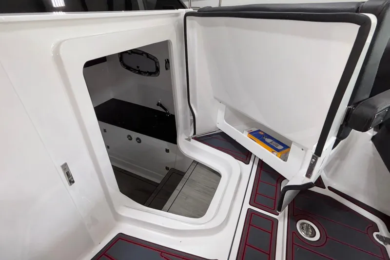 Slide: The Image of 2026 Monterey Elite 27 OB boat interior with open storage compartment and sleek design. - 33