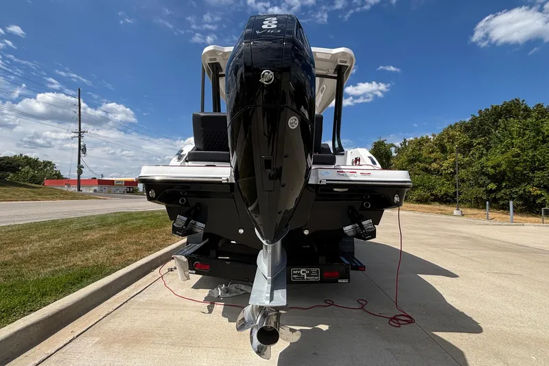 Slide: The Image of 2026 Monterey Elite 27 OB boat with powerful outboard motor, parked on concrete under blue sky. - 4