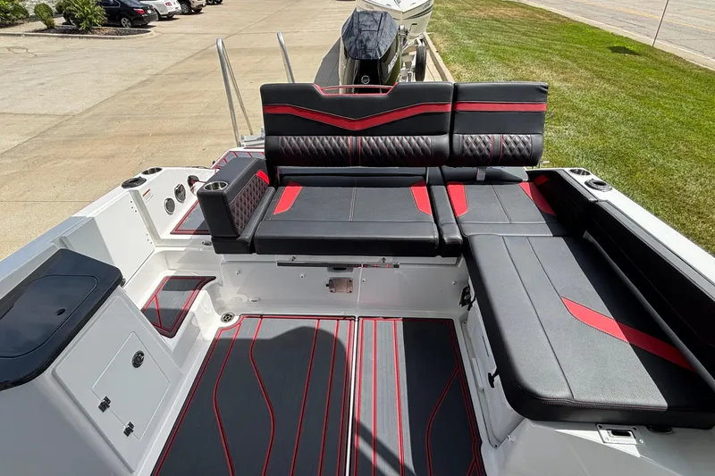 Slide: The Image of 2026 Monterey Elite 27 OB boat interior with black and red seating, modern design. - 8