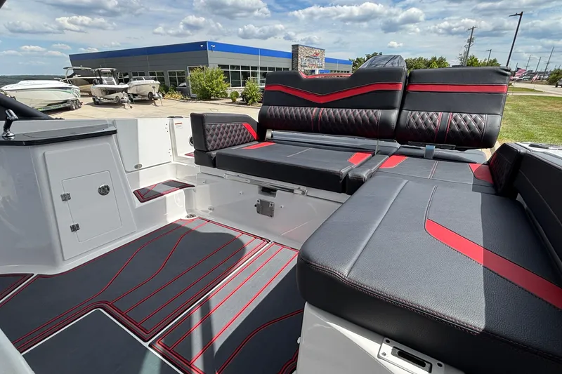 Slide: The Image of 2026 Monterey Elite 27 OB boat interior with stylish black and red seating. - 9