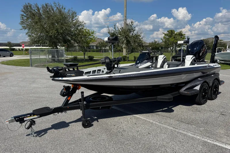 Slide: The Image of 2026 Skeeter FXR20 FLEX boat on trailer in sunny outdoor setting. - 14