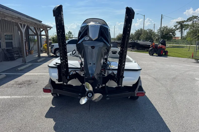 Slide: The Image of 2026 Skeeter FXR20 FLEX boat on trailer, rear view in parking lot. - 20