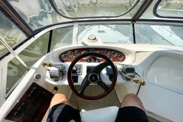 Slide: The Image of Cockpit view of 2001 Sea Ray 420 Aft Cabin yacht with steering wheel and controls. - 15