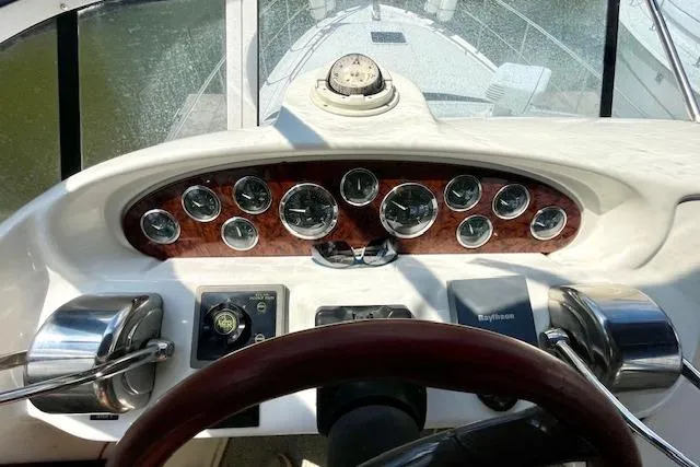 Slide: The Image of Cockpit view of 2001 Sea Ray 420 Aft Cabin with instrument panel and steering wheel. - 16