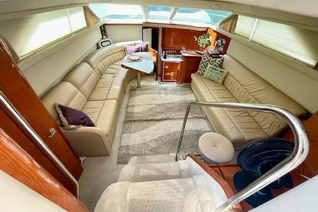 Slide: The Image of Luxurious interior of 2001 Sea Ray 420 Aft Cabin yacht with plush seating and elegant decor. - 19