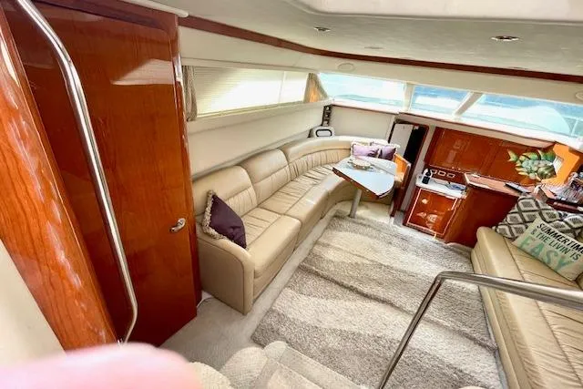 Slide: The Image of Luxurious interior of 2001 Sea Ray 420 Aft Cabin yacht with plush seating and elegant wood finishes. - 21