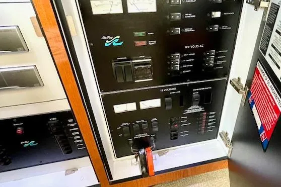 Slide: The Image of Electrical control panel of 2001 Sea Ray 420 Aft Cabin yacht, showing switches and meters. - 25
