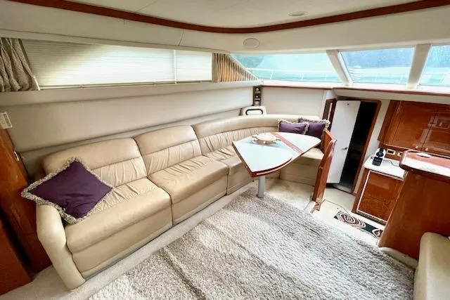 Slide: The Image of Luxurious interior of 2001 Sea Ray 420 Aft Cabin yacht with plush seating and elegant decor. - 27
