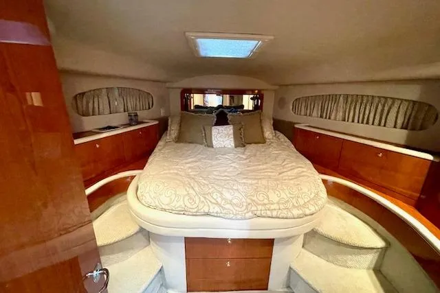 Slide: The Image of Luxurious cabin interior of 2001 Sea Ray 420 Aft Cabin yacht with plush bedding. - 31