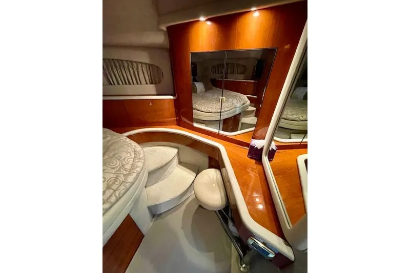 Slide: The Image of Luxurious interior of 2001 Sea Ray 420 Aft Cabin with elegant wood finish and plush seating. - 32
