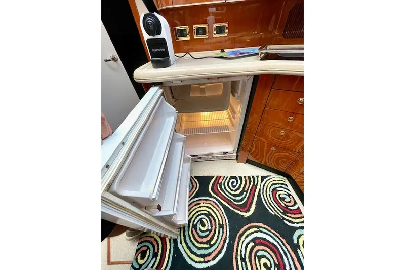 Slide: The Image of Open fridge in 2001 Sea Ray 420 Aft Cabin yacht kitchen with colorful rug. - 38