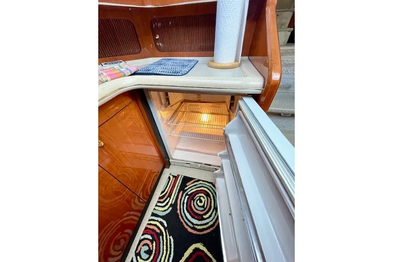 Slide: The Image of Open refrigerator in 2001 Sea Ray 420 Aft Cabin yacht kitchen with colorful rug. - 39